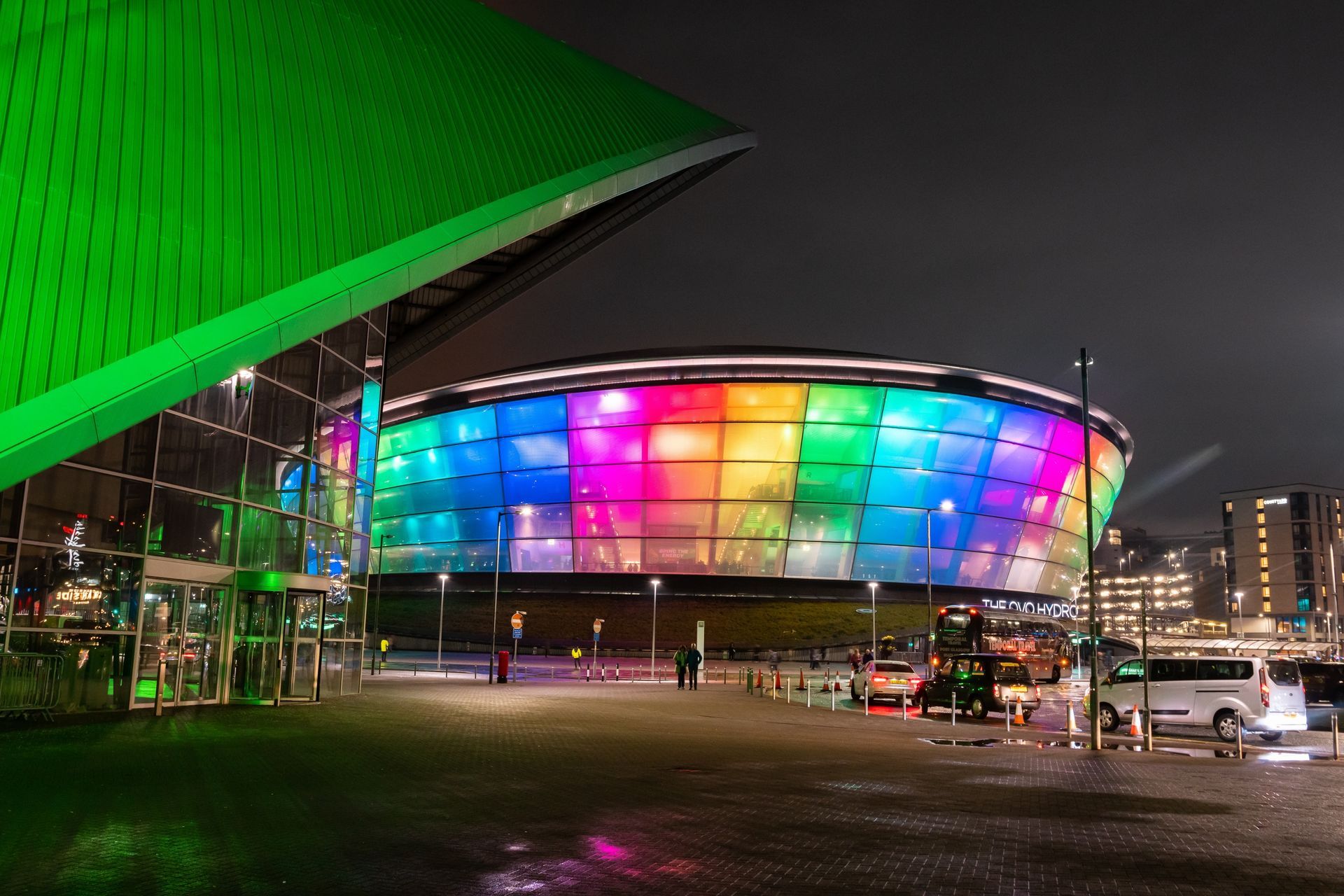 A large building with a lot of lights on it at night.
