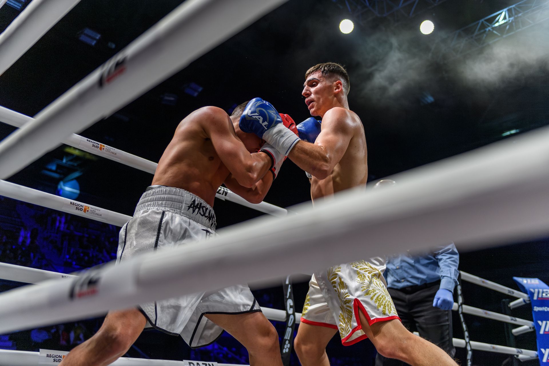Two men are boxing in a boxing ring.