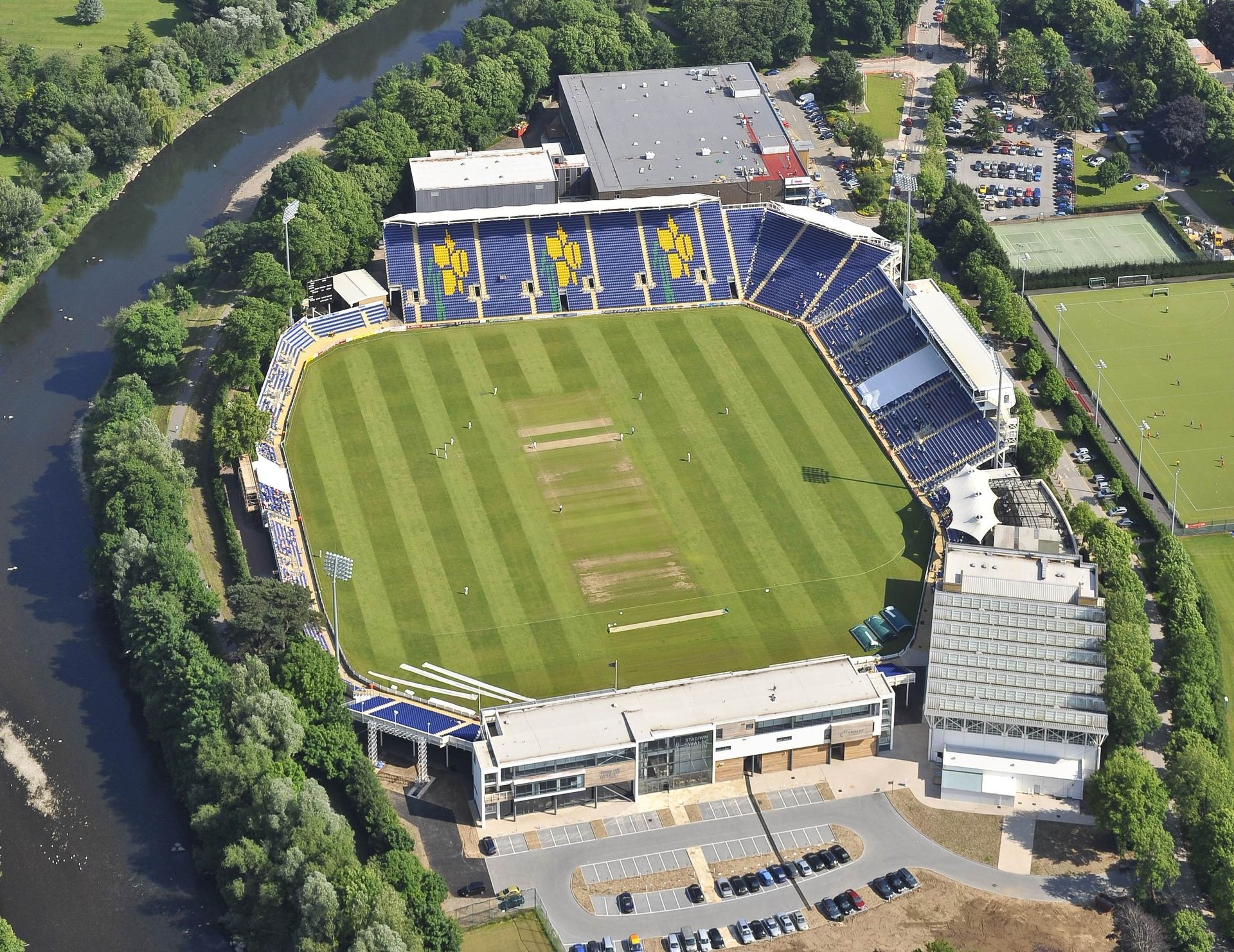 An aerial view of a soccer stadium with a river in the background