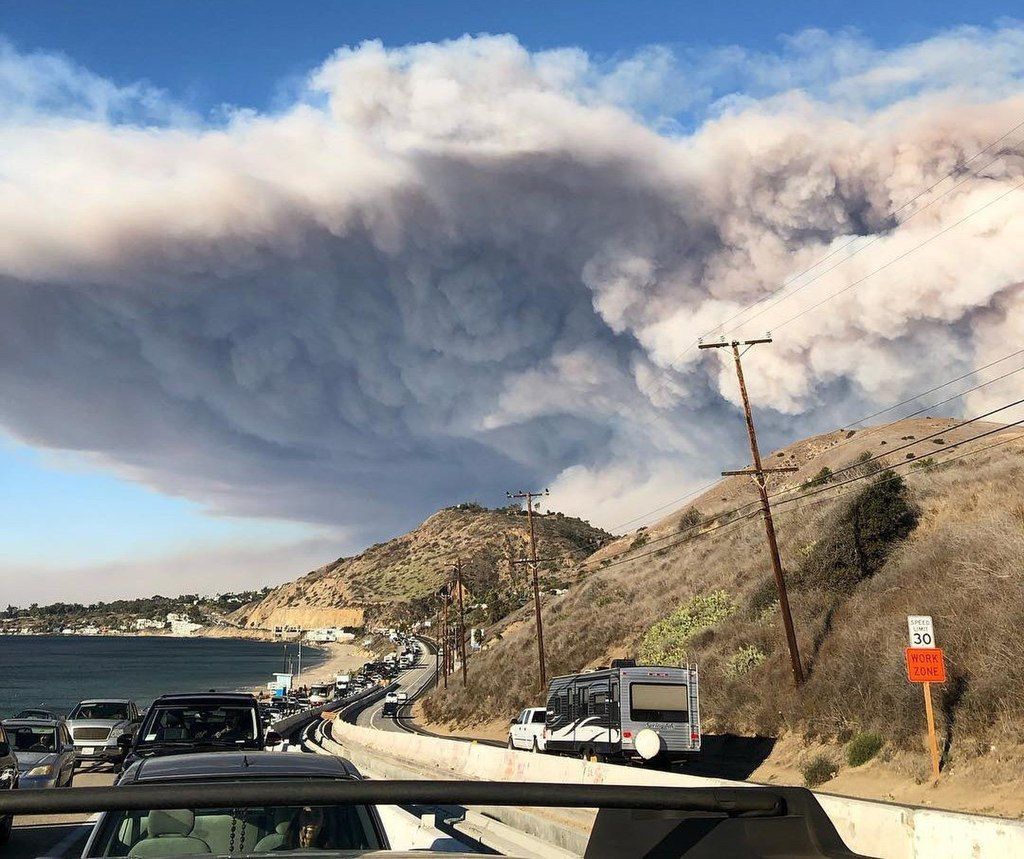 A large cloud of smoke is coming out of a mountain