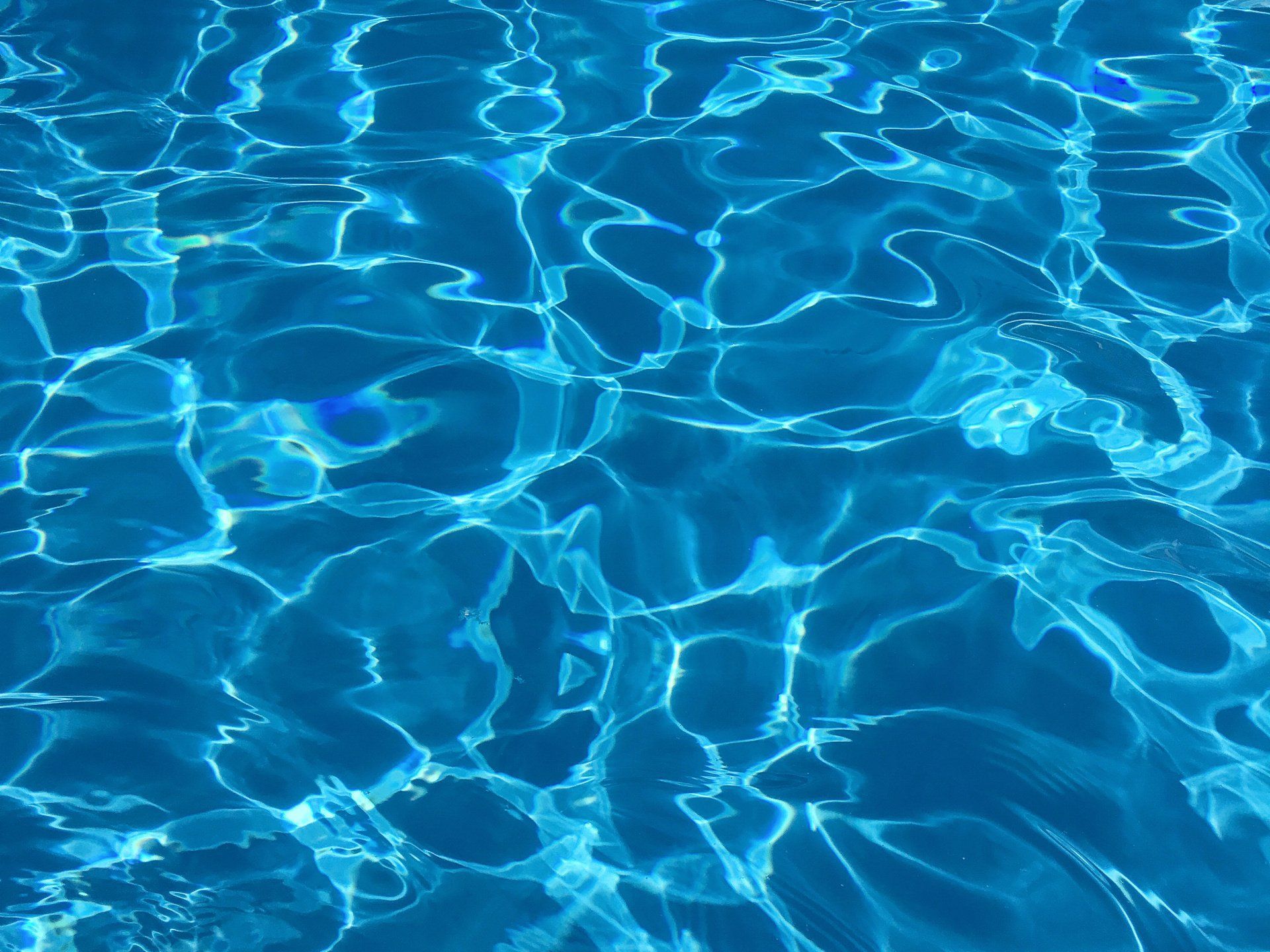 a close up of blue water in a swimming pool