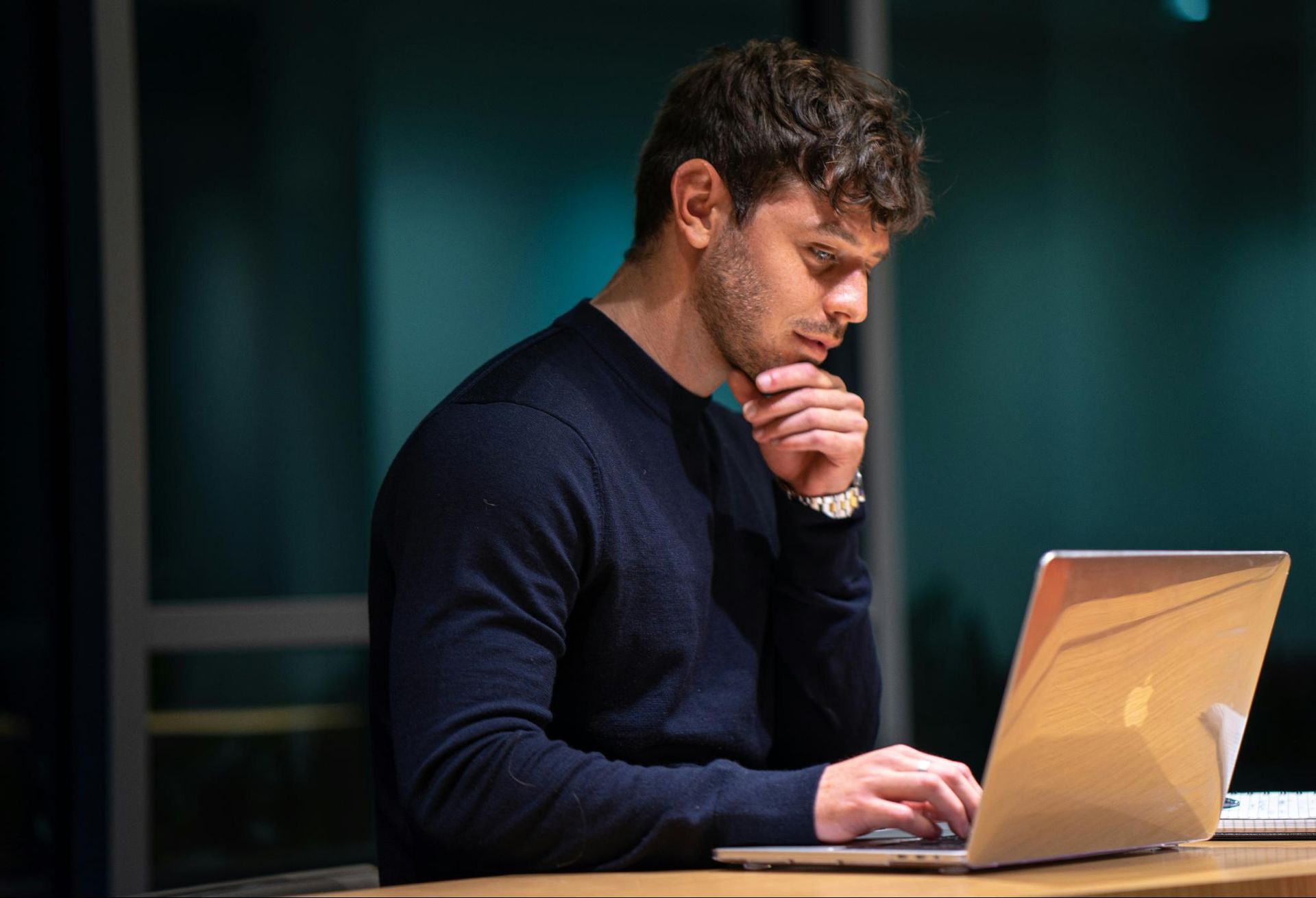 A man writing on his laptop