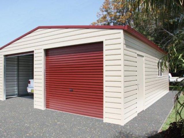 A white garage with a red garage door