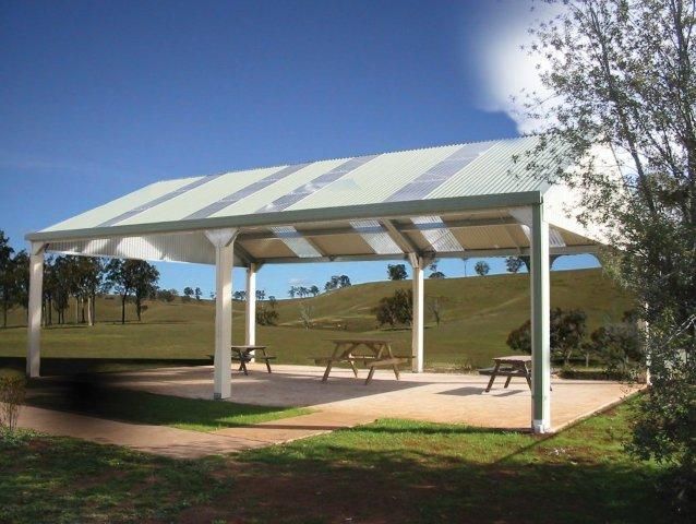 A covered area with picnic tables under a canopy