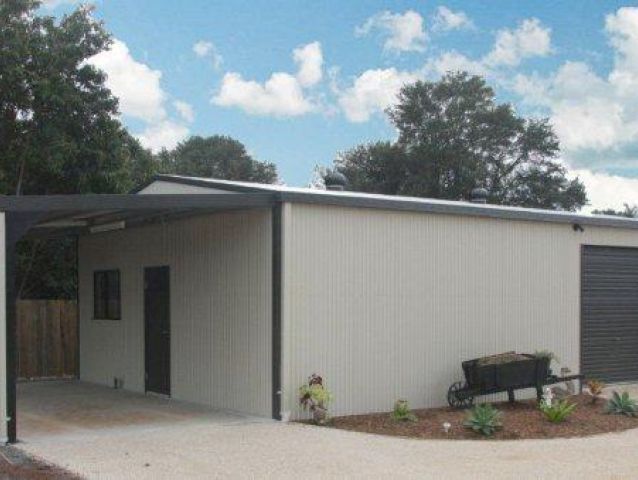 A white house with a black garage door