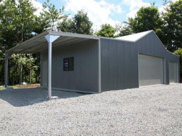 A gray garage with a canopy and a window