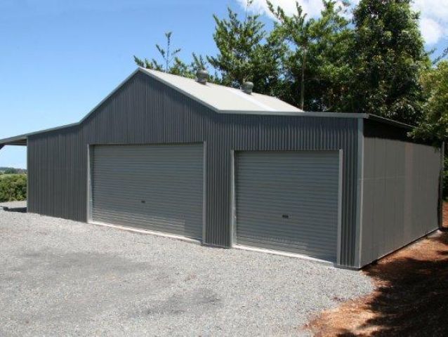 A garage with two garage doors and a roof