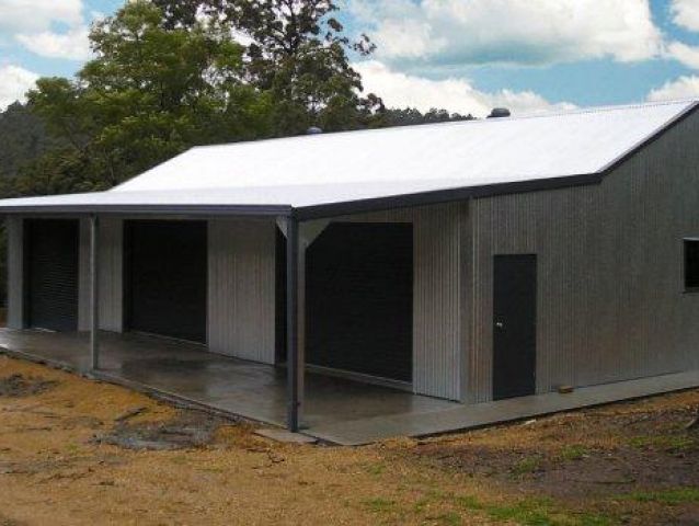 A large building with a white roof and black doors