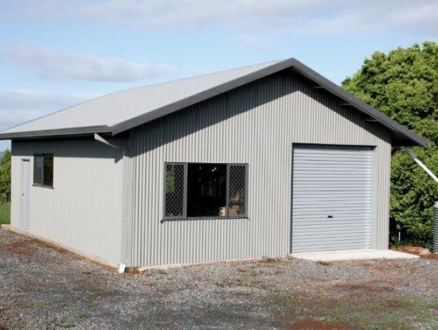 A small house with a garage door and a window