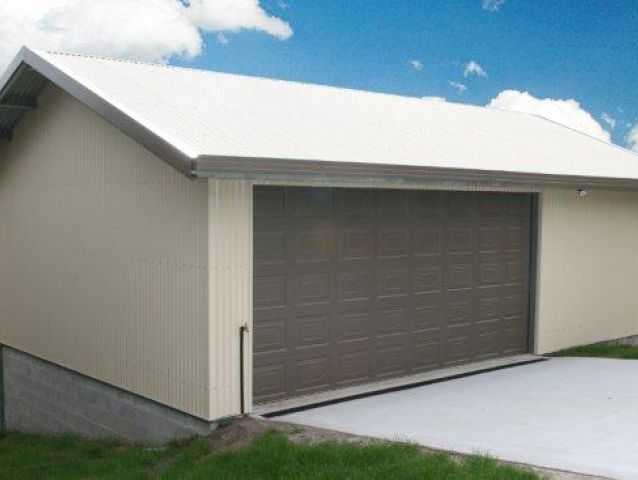 A garage with a white roof and a brown garage door