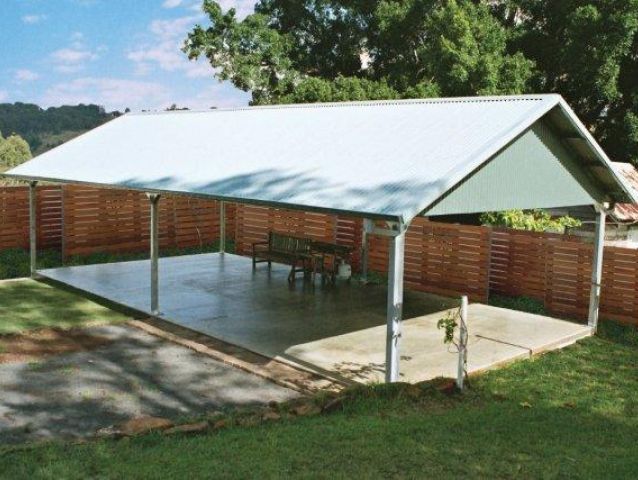A covered area with a table and chairs underneath it