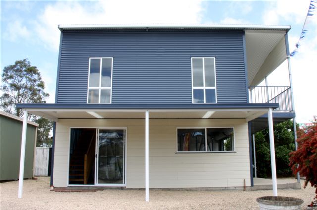 A blue and white house with a covered porch