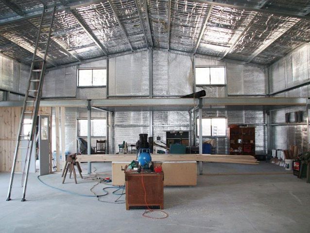 A large room with a ladder and a table in it