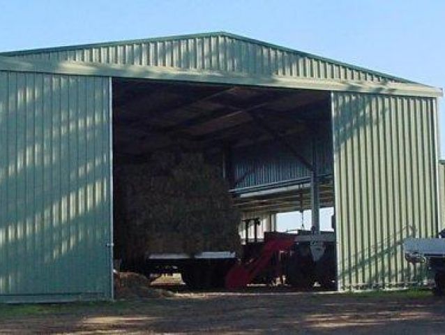 A shed with a lot of hay inside of it