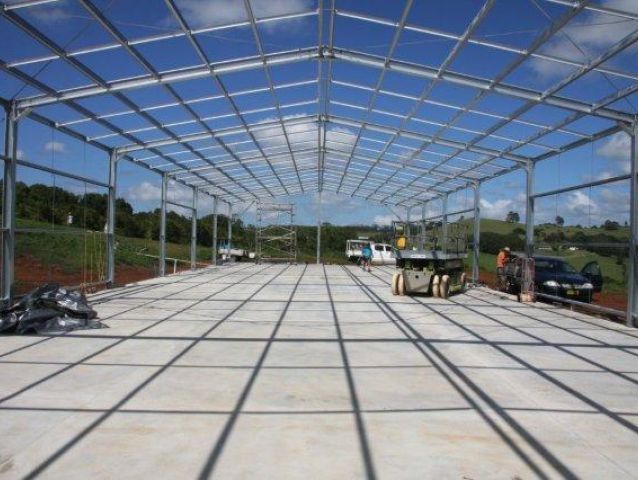 A large building under construction with a blue sky in the background