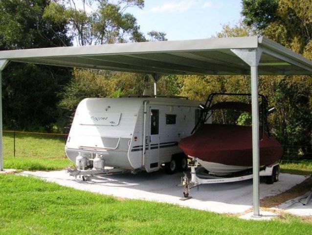 A caravan and a boat are under a canopy