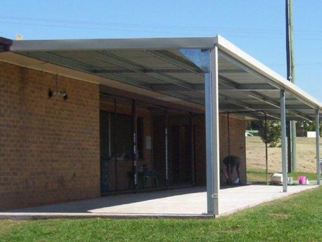 A brick building with a covered porch in front of it