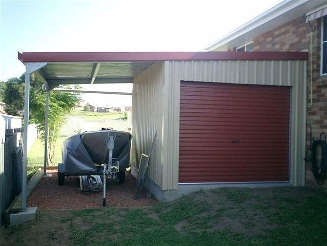 A boat is parked under a canopy in a garage