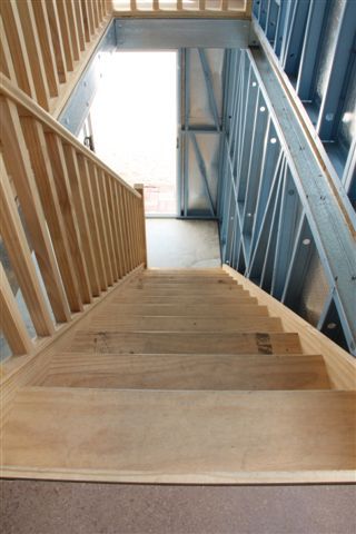 A wooden staircase leading up to the second floor of a building.