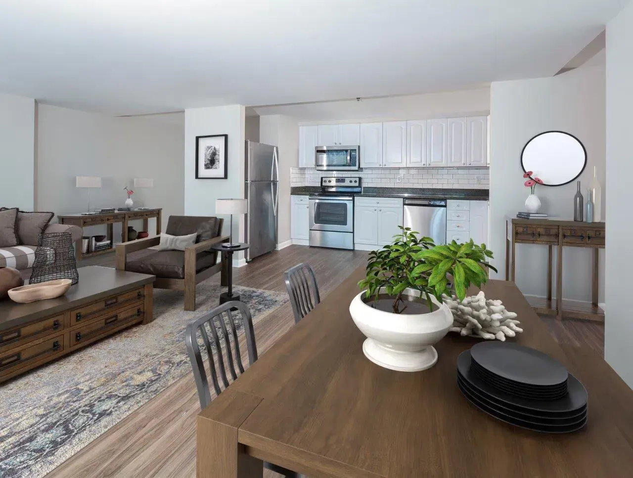 Open-concept living area with dining table, couch seating, and a modern kitchen.