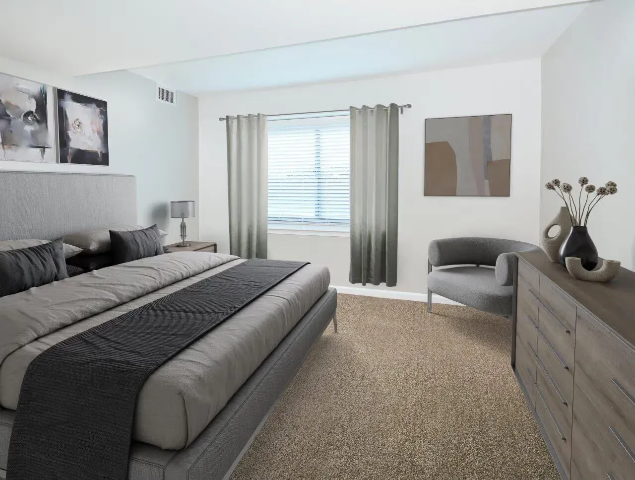 Modern bedroom with a large bed, dresser, seating area, and window with curtains.