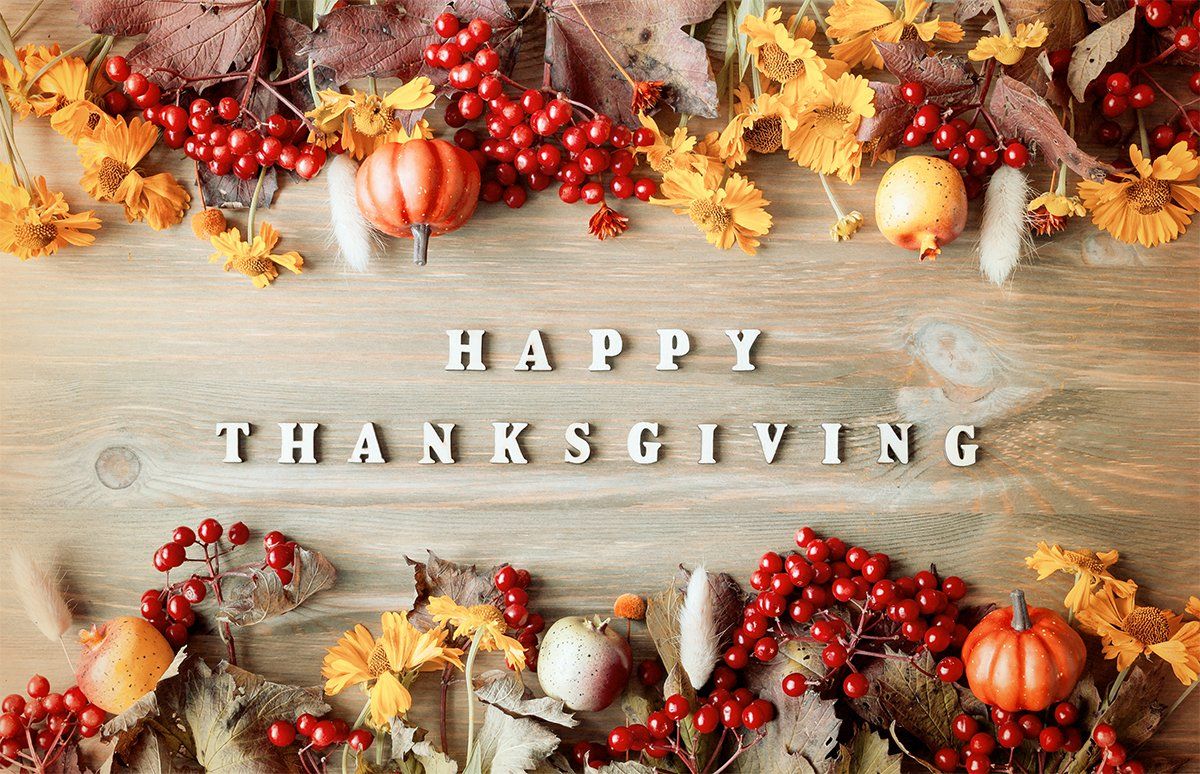 happy thanksgiving in the middle of leaves and pumpkins and flowers