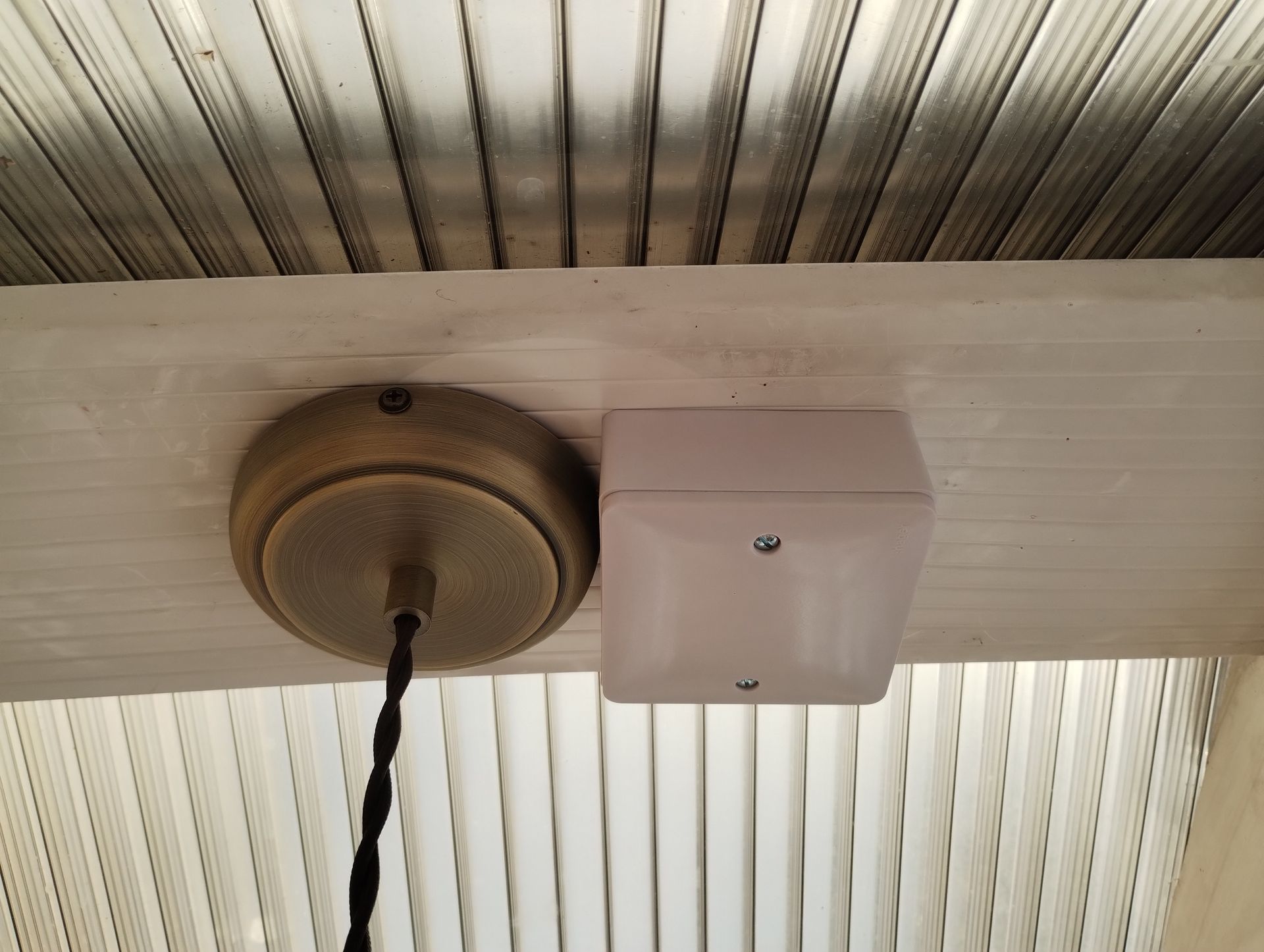 Wireless Quietic switch module in a pattress box next to a decorative light fitting