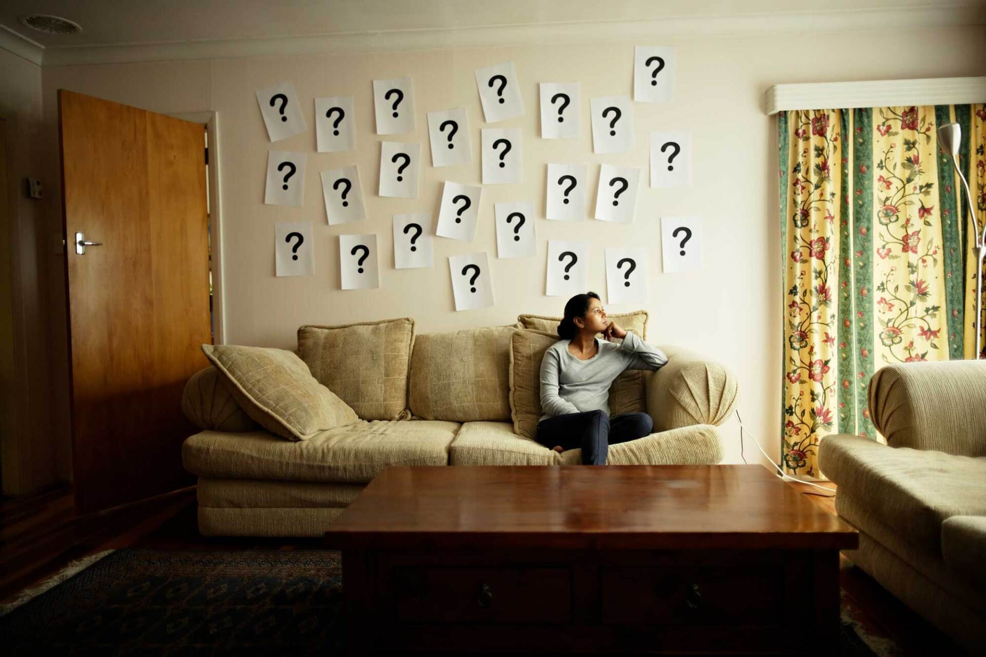 Question Marks on the Wall and a Woman Sitting on Sofa  — White Plains, NY — Dr. Henry B. Hartman