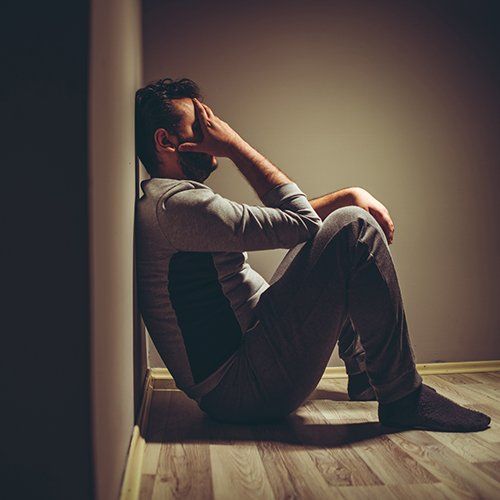 Depressed Man Sitting on Floor — White Plains, NY — Dr. Henry B. Hartman