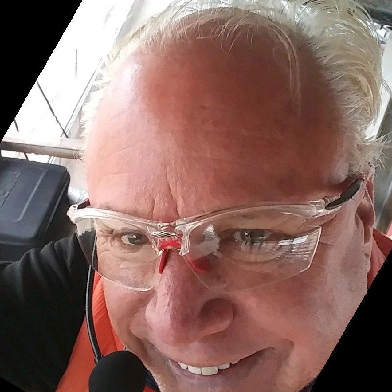 A close up of a man wearing glasses and a microphone