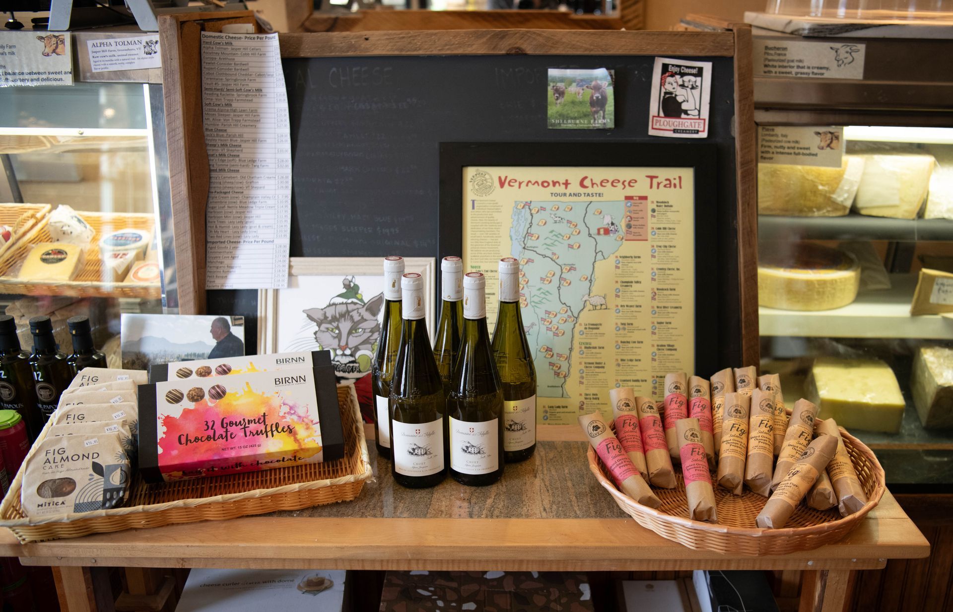 A table with bottles of wine and a map on it at The Wine & Cheese Depot