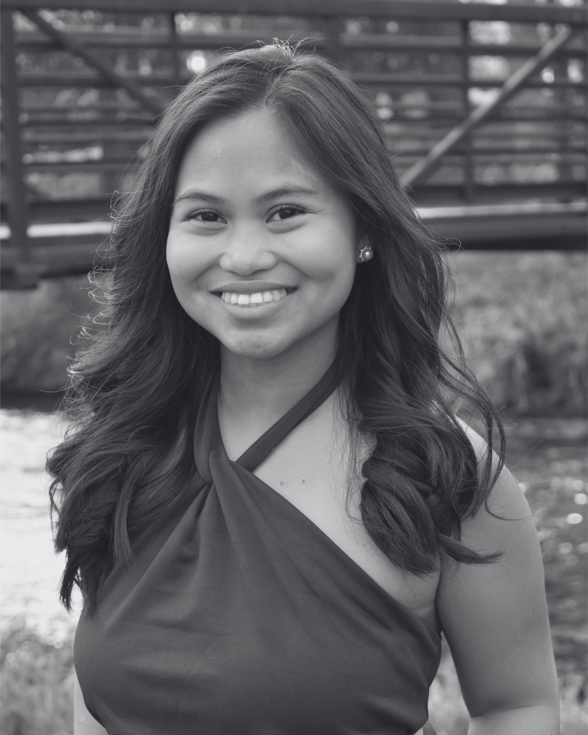 A black and white photo of a woman smiling for the camera.