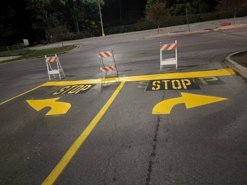 Asphalt road with yellow arrows indicating left and right turns; 