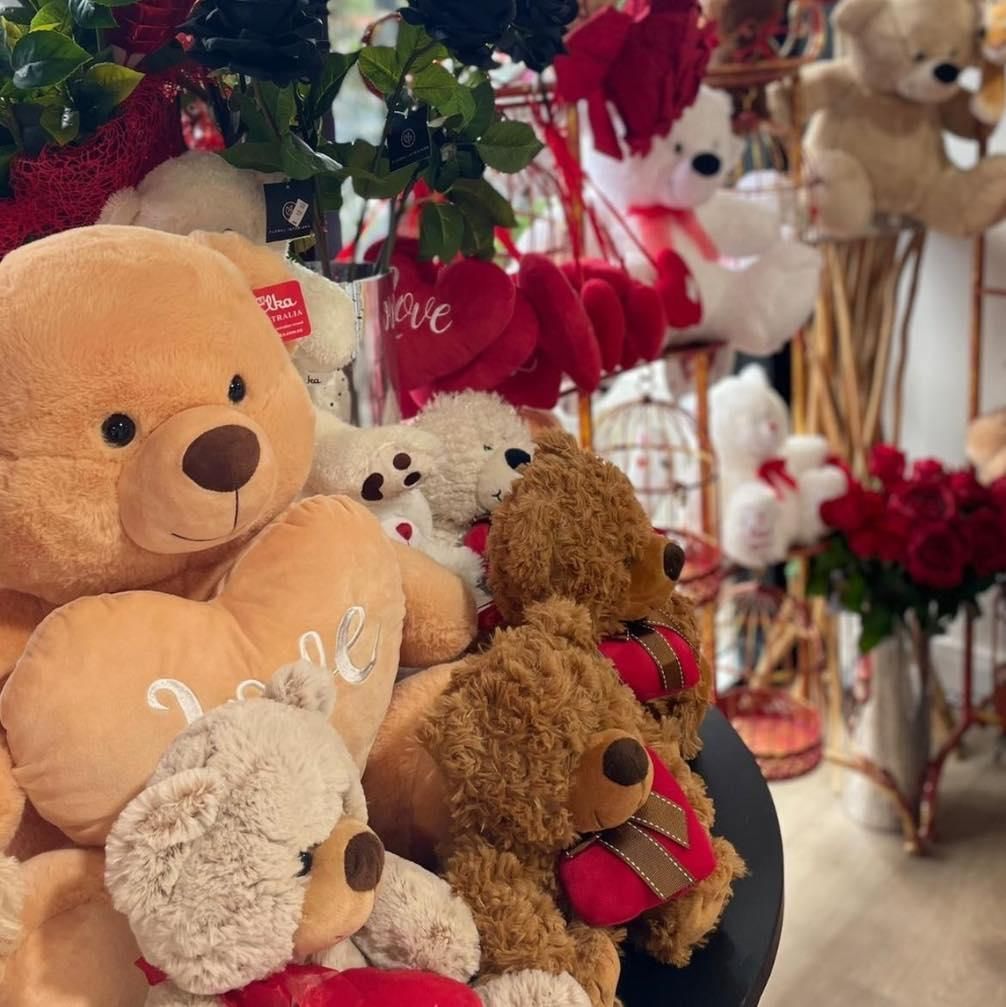 A Row of Teddy Bears Sitting on a Table — Floret In Lismore, NSW