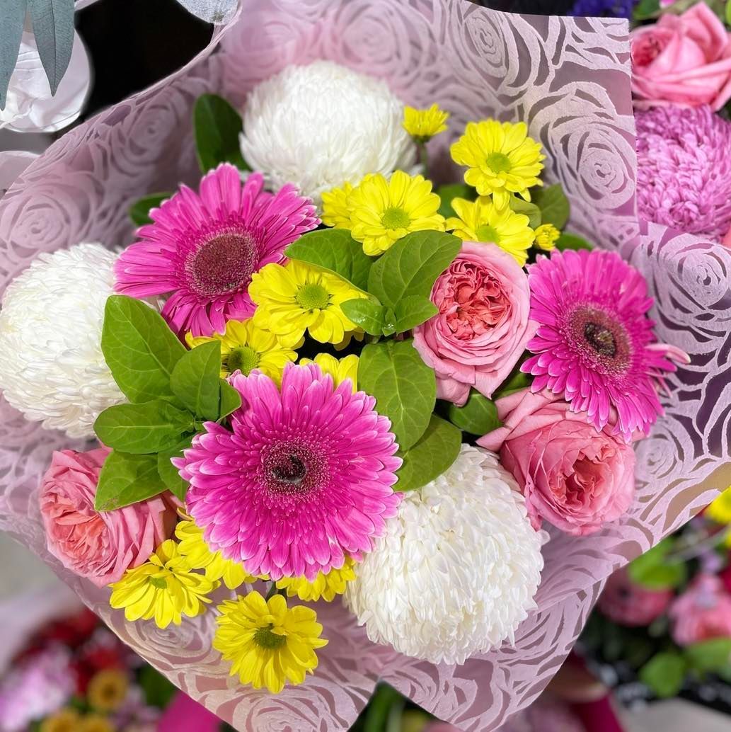 A Bouquet of Pink and Yellow Flowers Wrapped in Purple Paper — Floret In Lismore, NSW