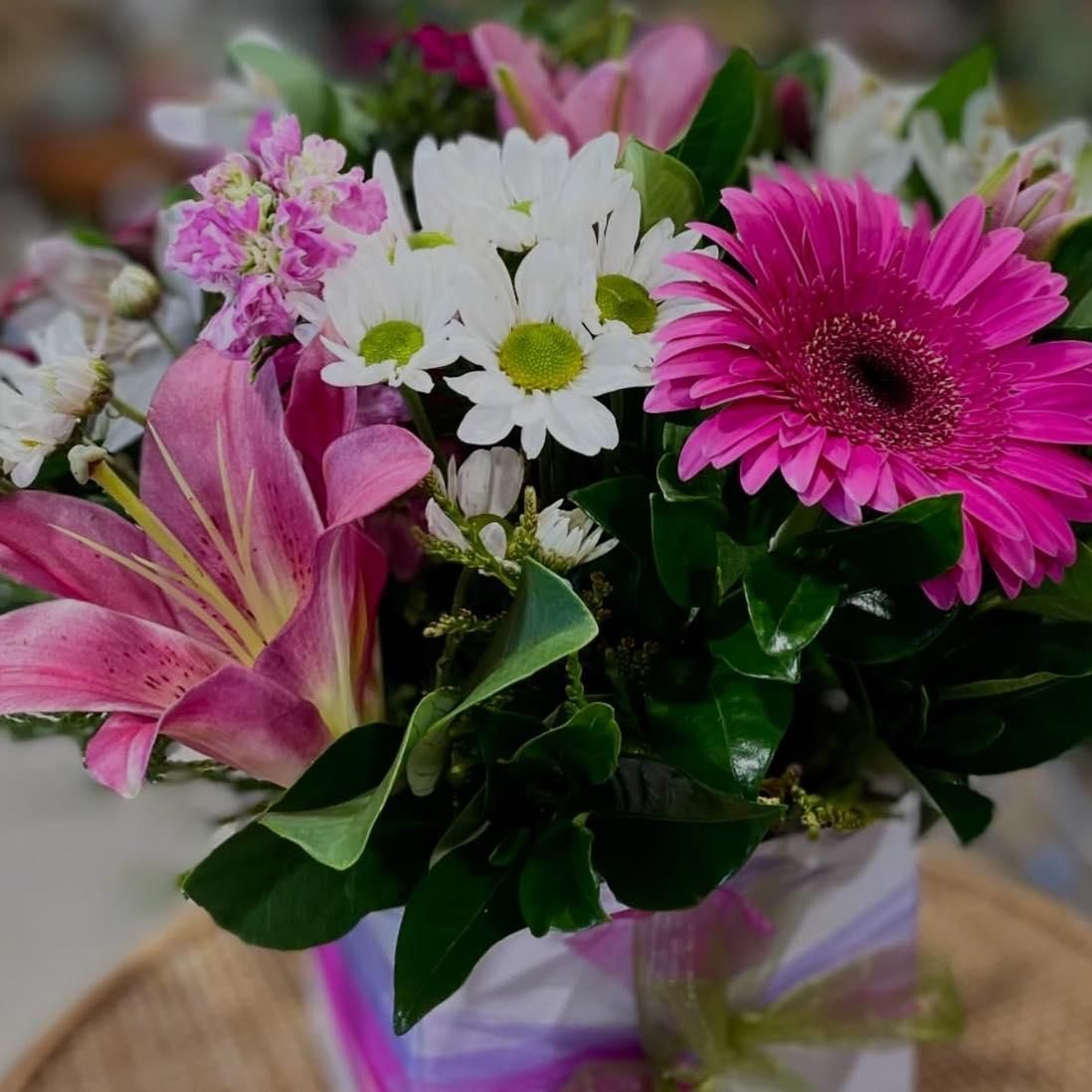 A Vase Filled With Pink and White Flowers on a Table — Floret In Lismore, NSW