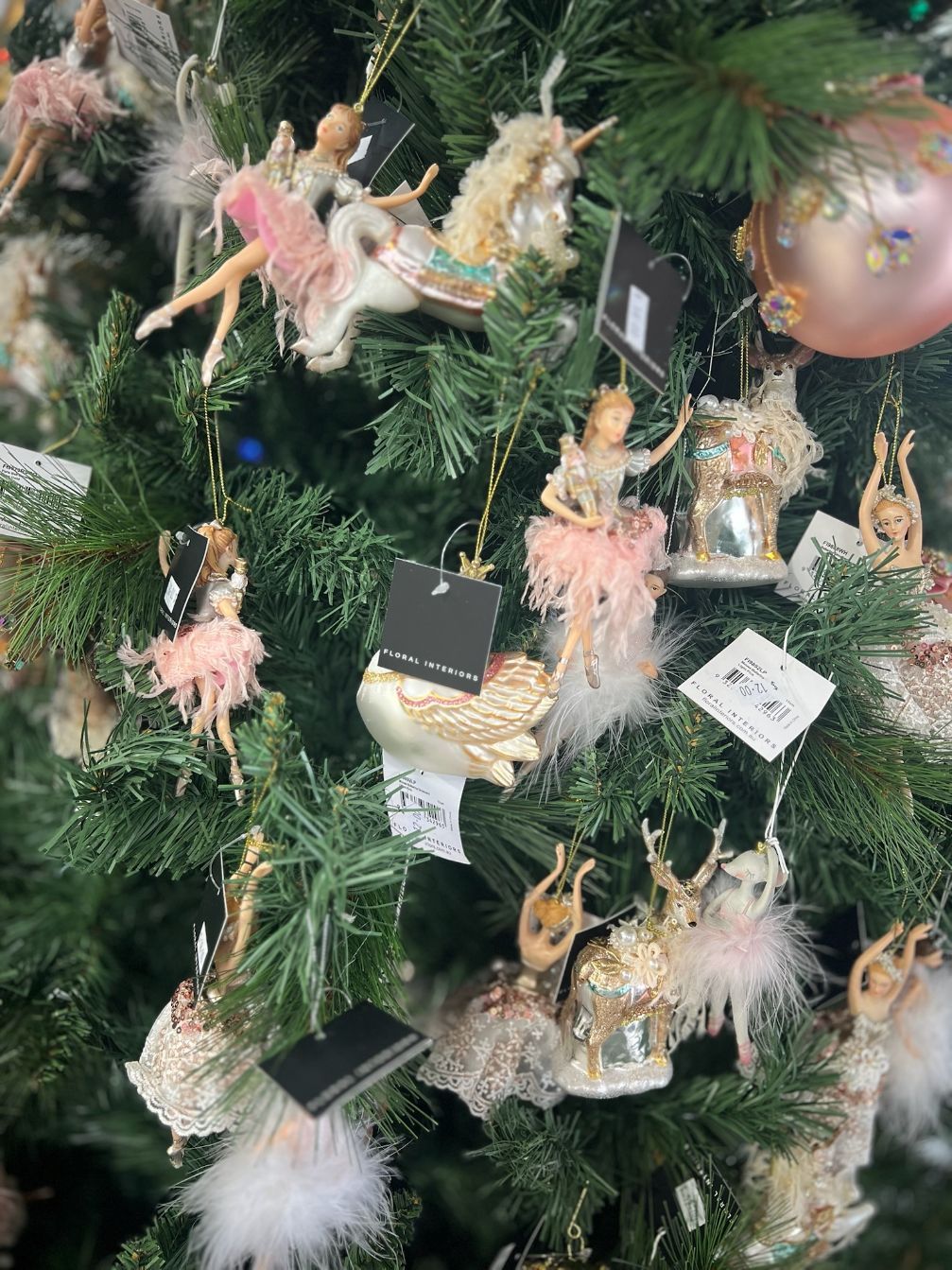 Christmas tree with ballerina ornaments; pink, gold, and white.