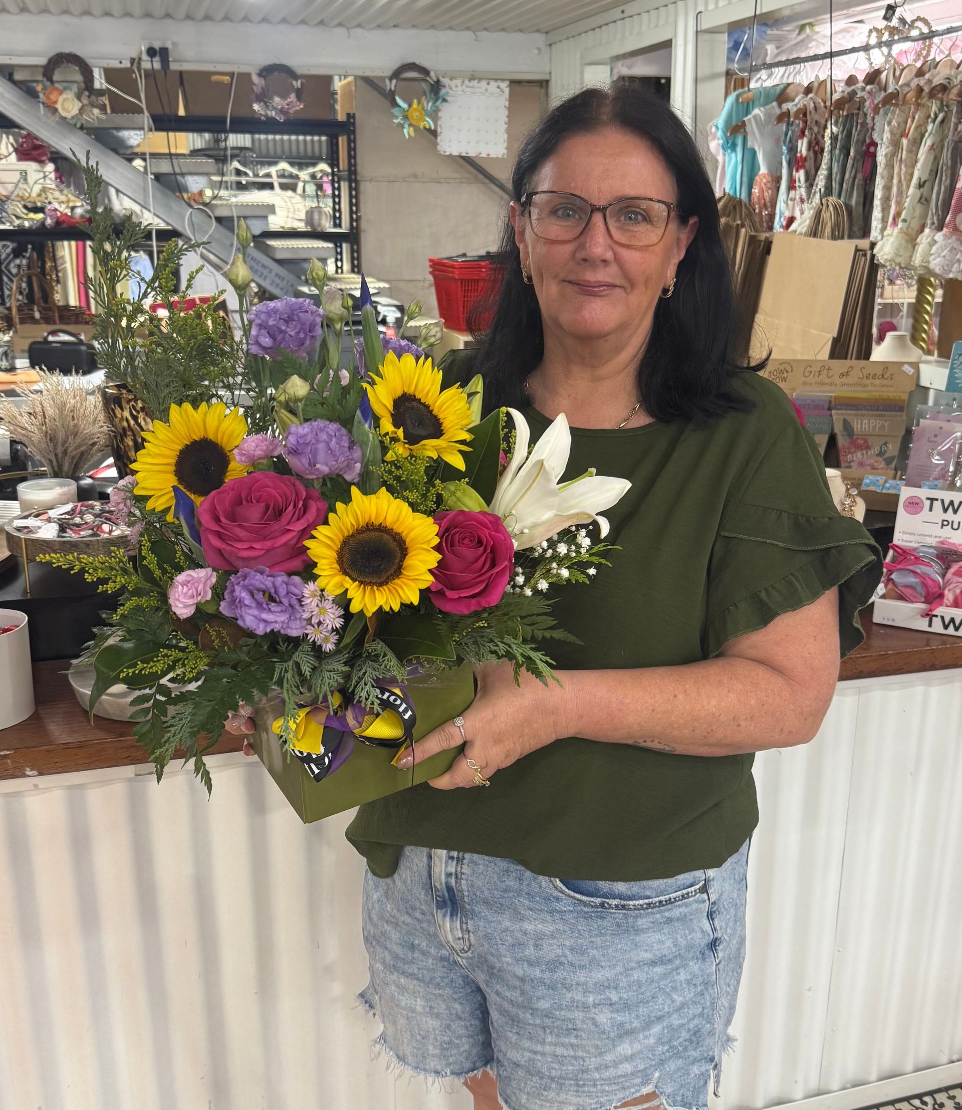 A Woman is Holding a Bouquet of Flowers in a Vase — Floret In Lismore, NSW