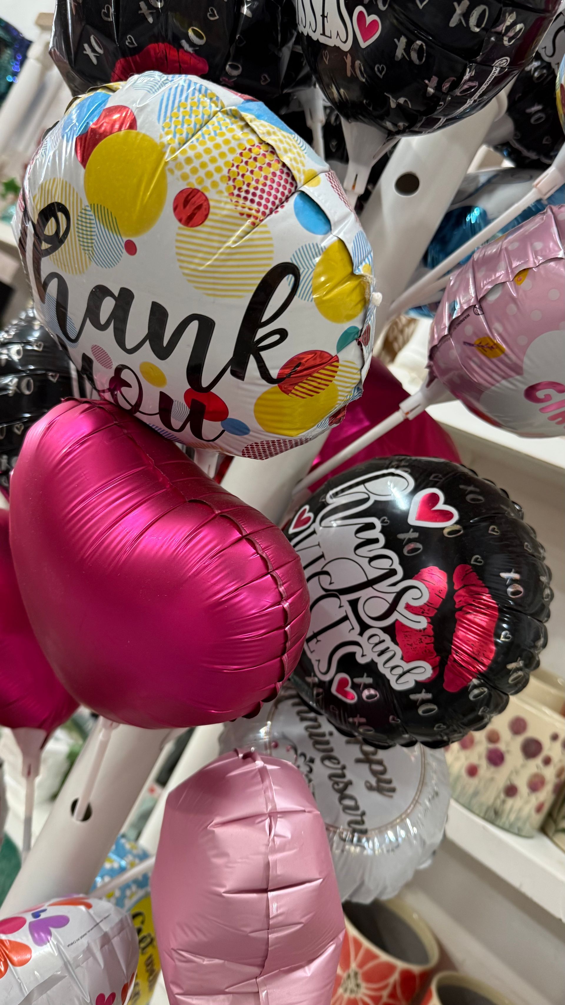 A Bunch of Balloons Are Hanging on a Rack — Floret In Lismore, NSW