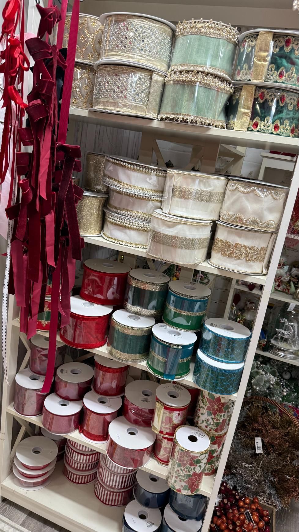 Shelves displaying various decorative ribbons in different colors and patterns. | Jingle Bell Christmas