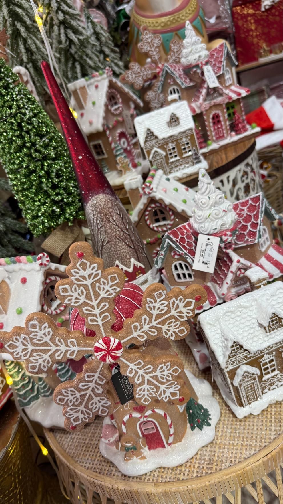 Gingerbread cookies and houses, festive display. Red, white, and brown with snow-like frosting, on a wooden tray. | Jingle Bell Christmas
