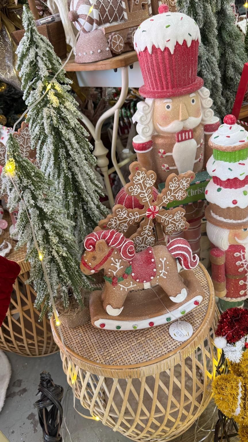 Christmas decor, including a gingerbread rocking horse, nutcracker, and stacked cake figurines. | Jingle Bell Christmas