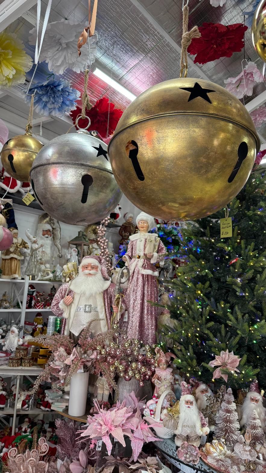 Christmas decorations in a shop, including large gold and silver bells hanging from the ceiling. | Jingle Bell Christmas