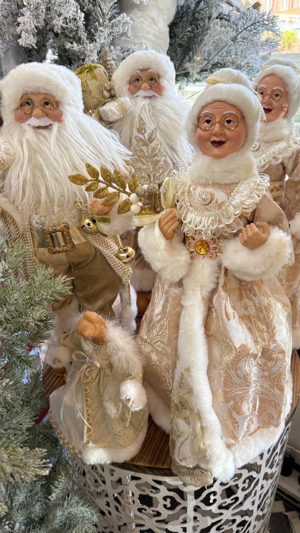 Christmas figurines: Santa, Mrs. Claus, holding gold decorations, wearing white and gold outfits. | Jingle Bell Christmas