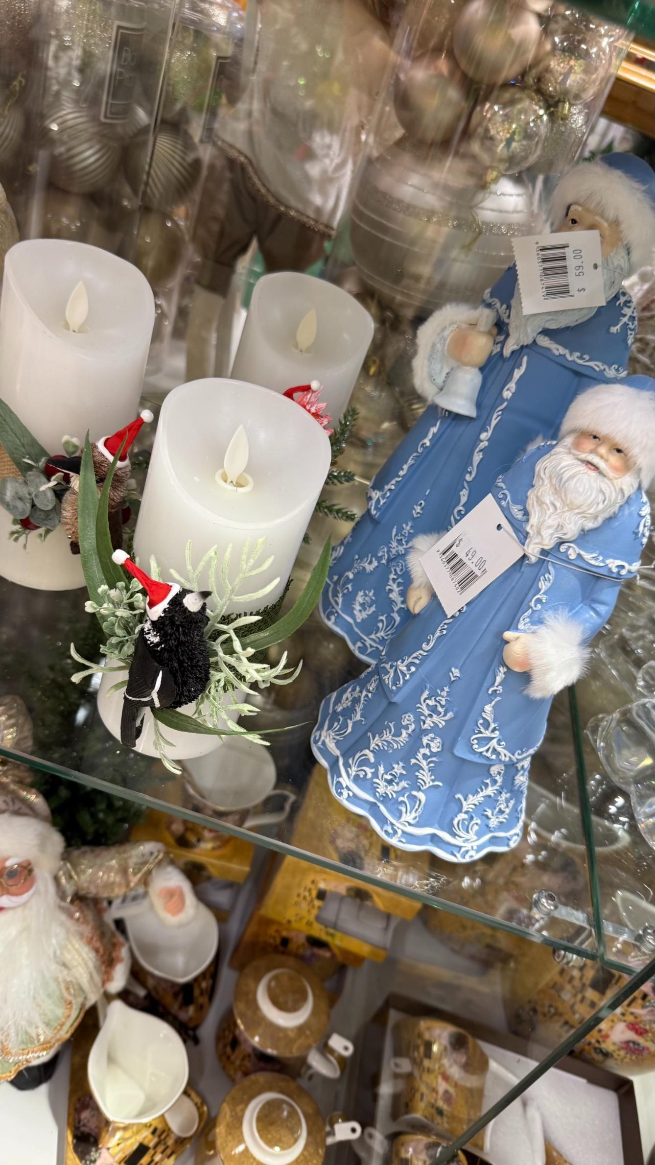 Christmas decorations on display, including candles and Santa figurines. | Jingle Bell Christmas