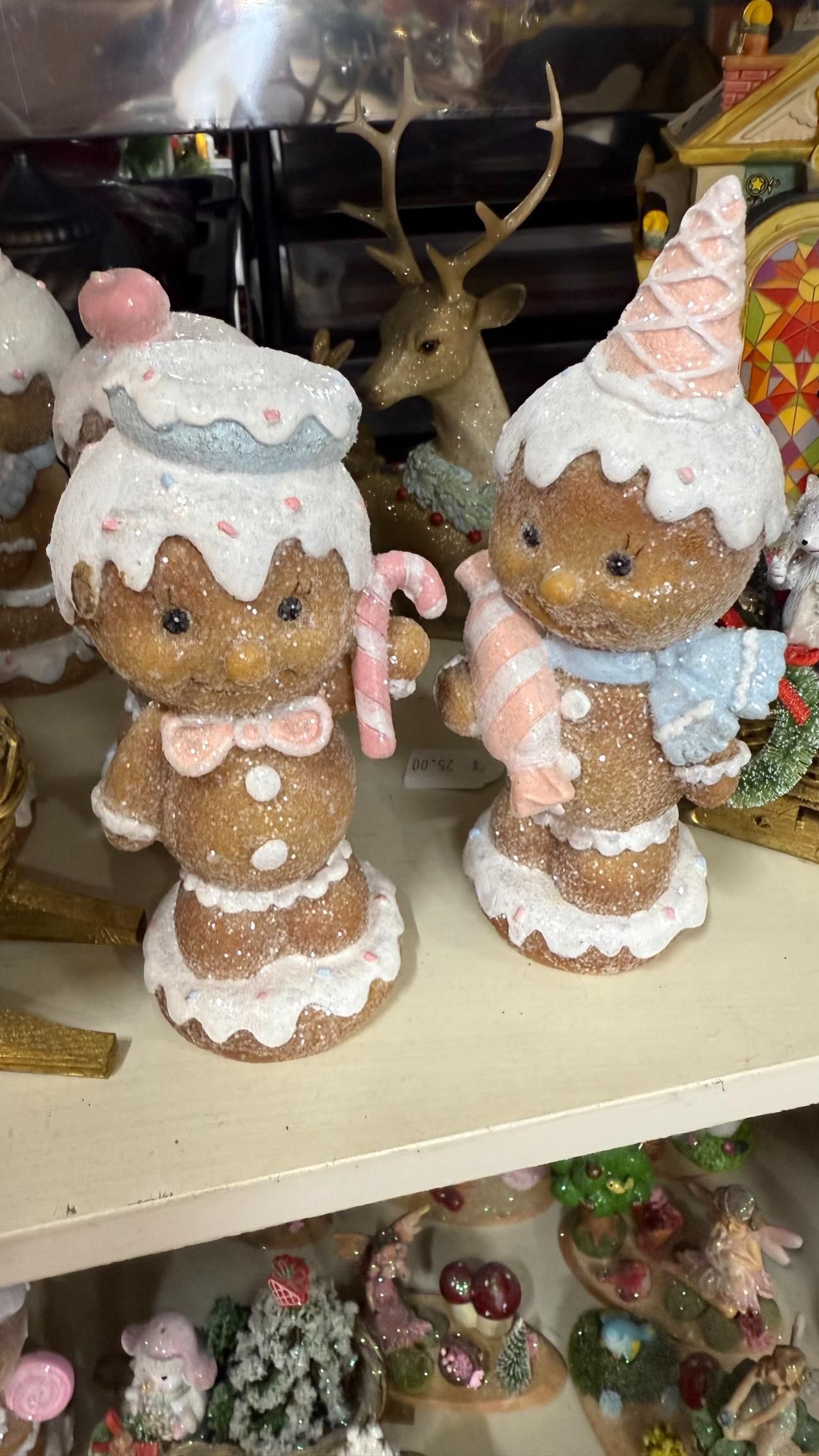 Two gingerbread figures with frosting and holding candy canes, next to a reindeer figure. | Jingle Bell Christmas