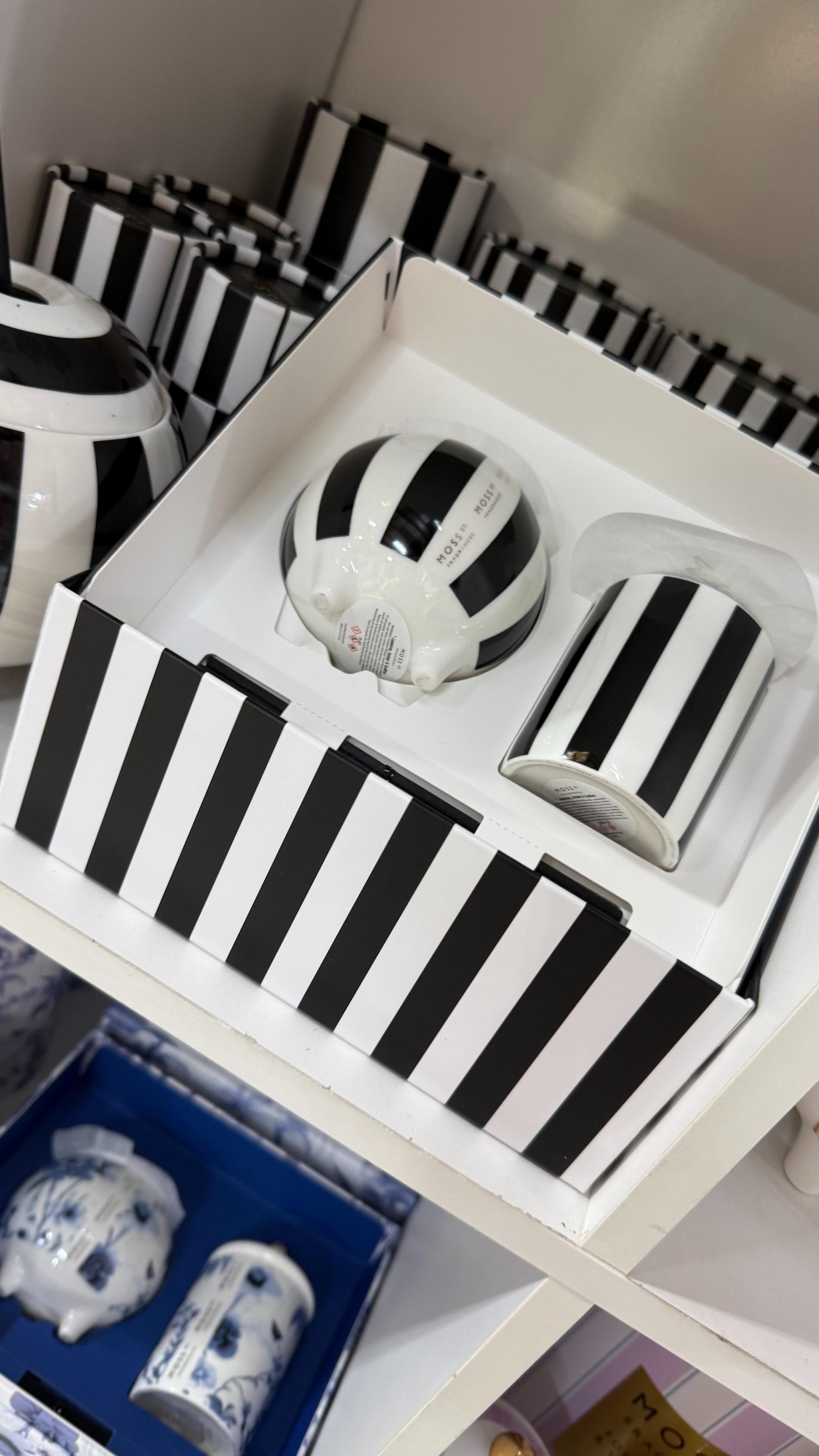 Black and white striped ceramic items in a display box, with matching patterns. | Jingle Bell Christmas