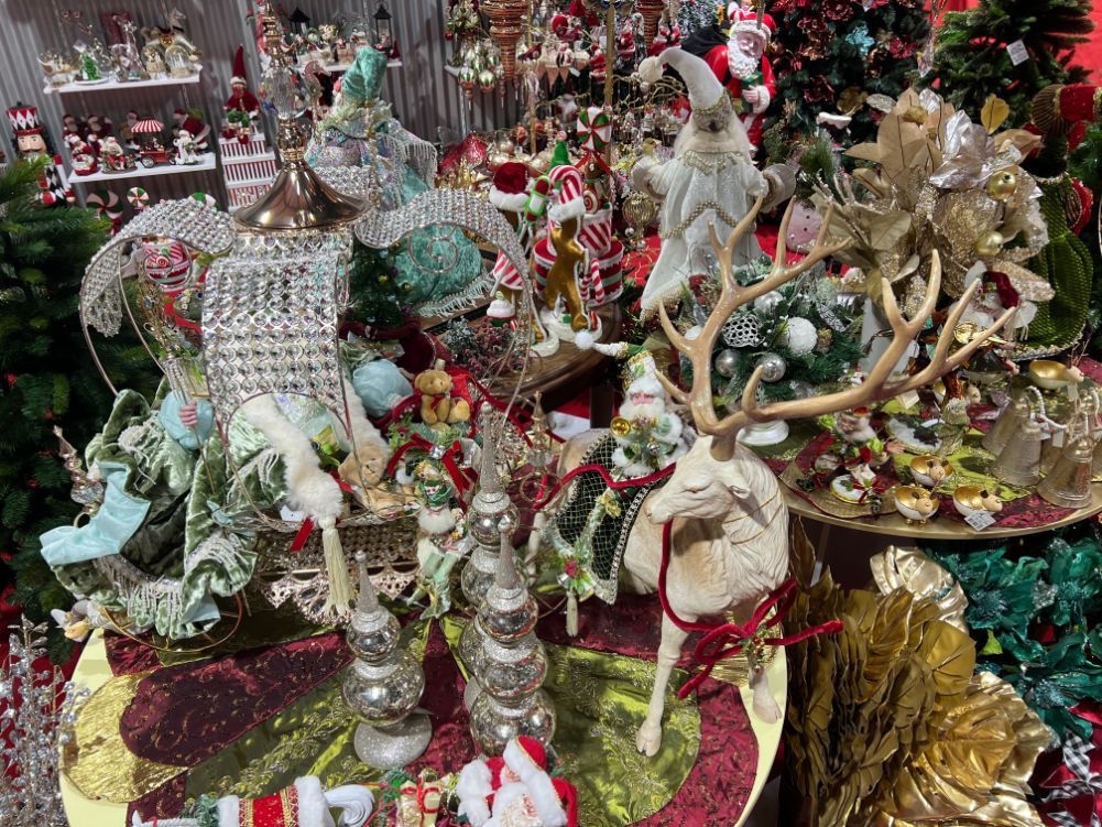 Christmas decorations and figurines on display, including a reindeer, Santa, and ornate embellishments.