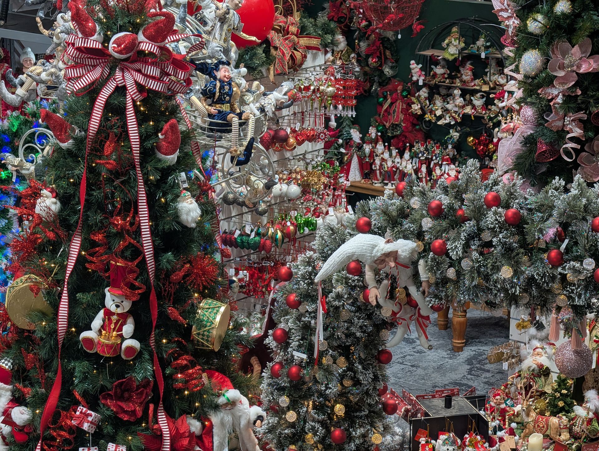 Shelves of Holiday Ornaments and Figurines Beside a Decorated Christmas Tree in A Shop — Jingle Bell Christmas In Casino, NSW
