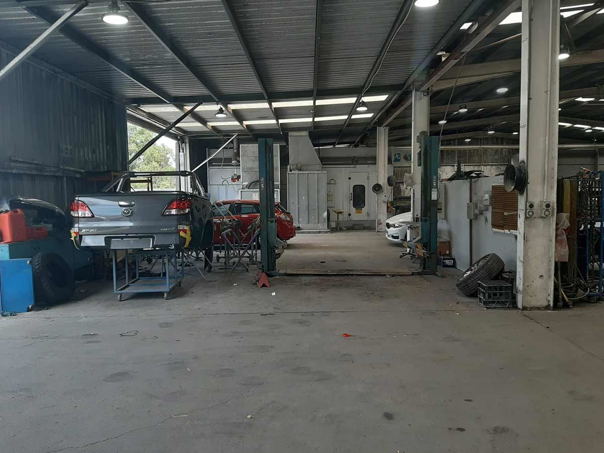 A Car is Sitting on a Lift in a Garage β Vanderpoel Smash Repairs in Tuggerah, NSW